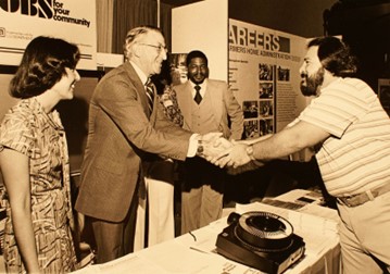 Deputy Assistant Secretary of Commerce for Economic Development Hal Williams greets an attendee at the annual conference of the National Council of La Raza in 1978.