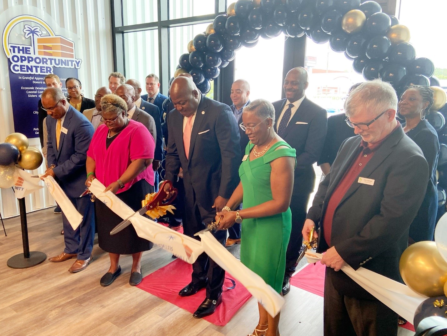 Leaders from the four partners in The Opportunity Center,  pictured left to right: Bernie Mazyck, SCACED; Dr. Jennie Stephens, Center for  Heirs Property Preservation; Jerome Heyward, Mayor Pro Tempore of North  Charleston; Dorothea Bernique, Increasing HOPE; and Don Oglesby, Homes of Hope,  gather to cut the ceremonious ribbon, marking the official opening of the new  building.
