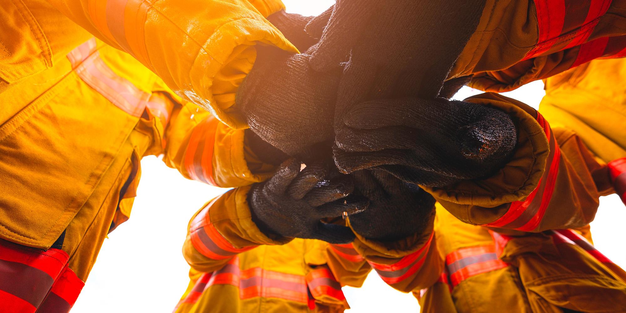 Firefighters putting their hands together